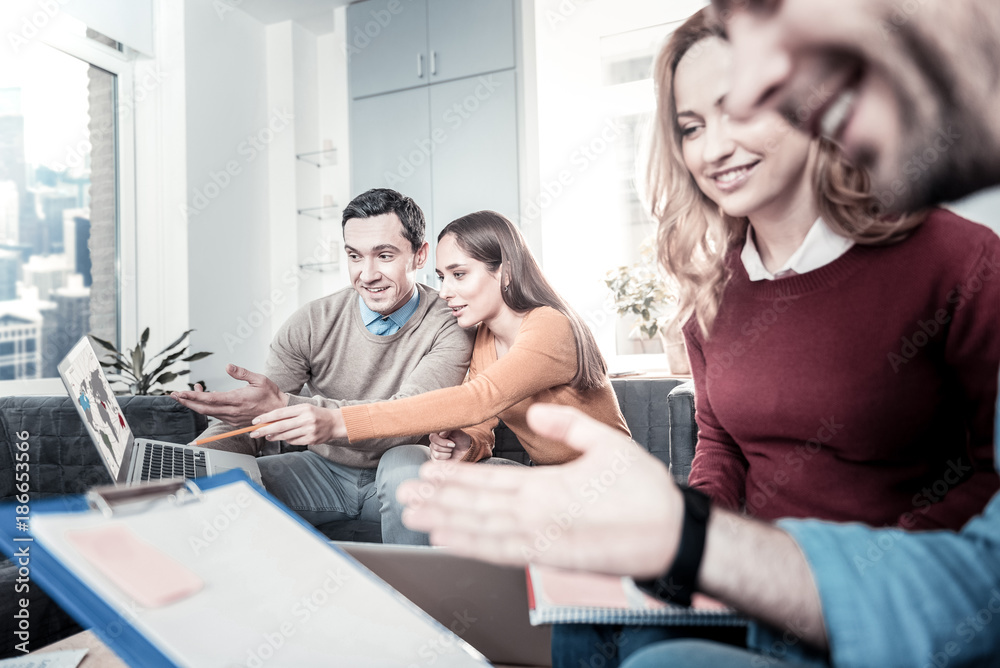 Check it out. Interested perspective pleasant employees working in pairs in the office sitting on the sofa and using the laptop. Check it out. Interested perspective pleasant employees working in pairs in the office sitting on the sofa and using the laptop.