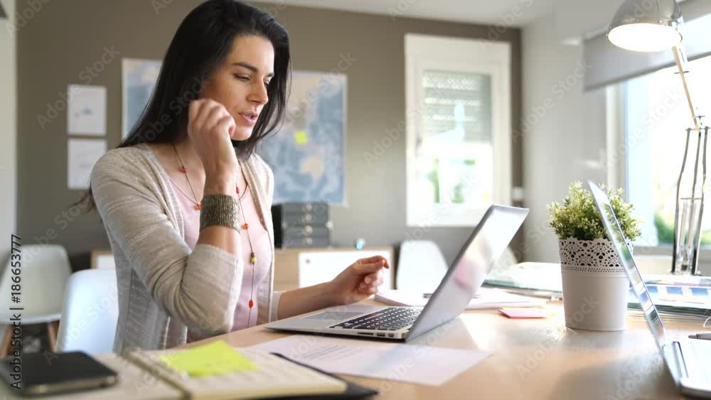 Businesswoman in office working on laptop Businesswoman in office working on laptop