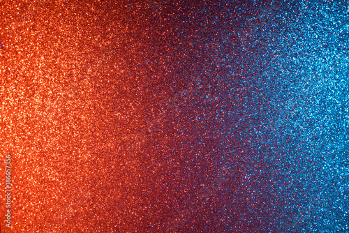 Red and blue abstract glitter background, shiny blurred bokeh on corners and sharp in center