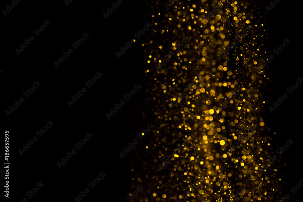 Falling glitter dust bright bokeh border on black background with copy space Falling glitter dust bright bokeh border on black background with copy space