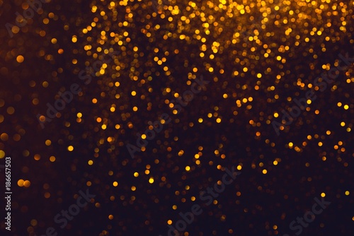 Shiny glitter bokeh. Glitter abstract background with golden lights and blank background.