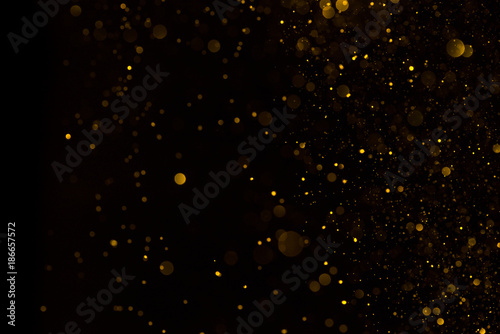 Falling golden glitter dark background
