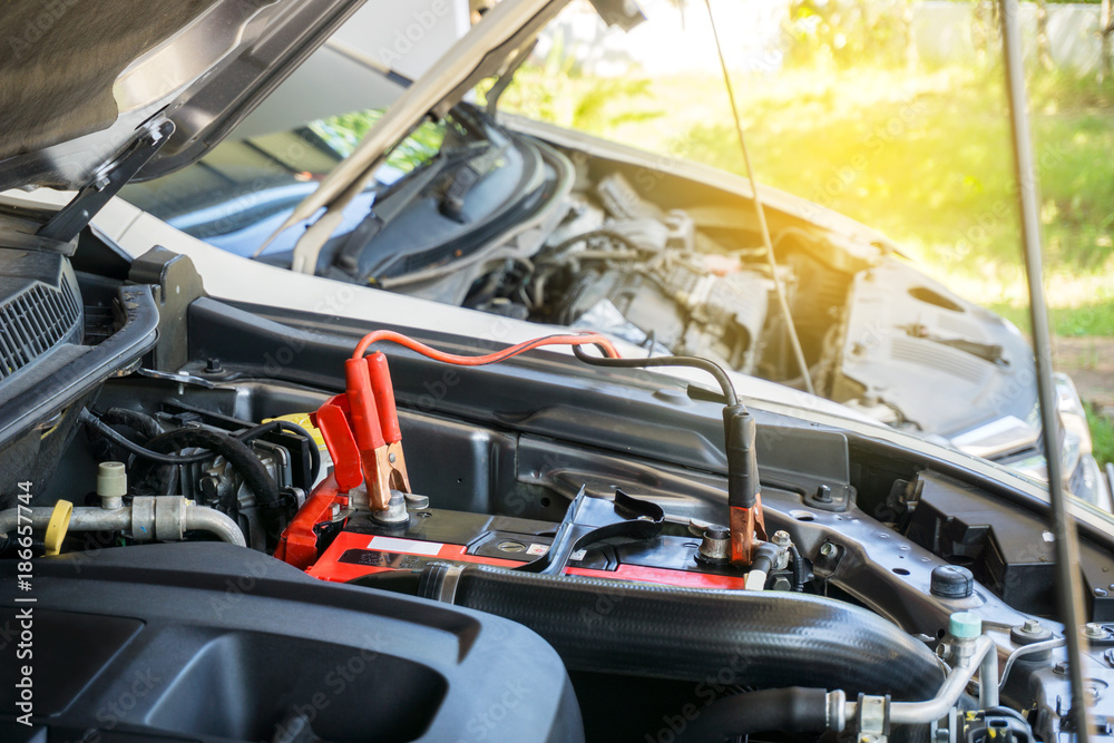 Selective focus Battery car with battery jumper cables charge a dead battery Selective focus Battery car with battery jumper cables charge a dead battery