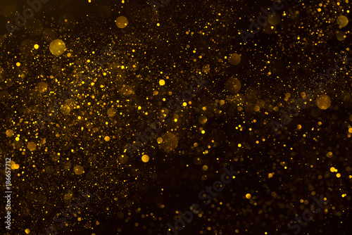 Golden stardust flow glitter shiny abstract background photo