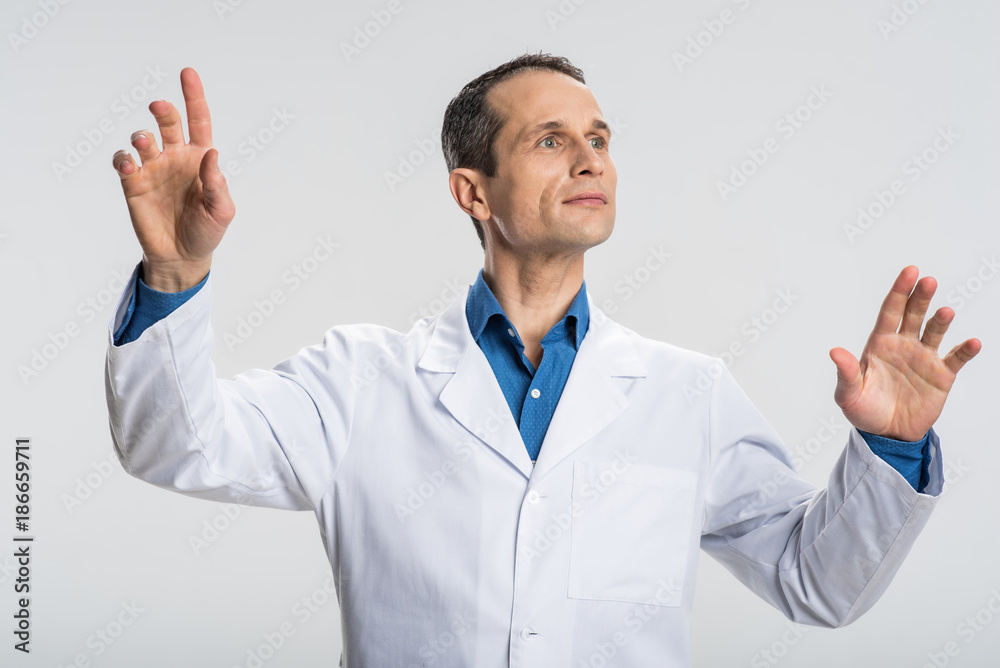 Do it now. Ambitious nice male physician waving hands and looking aside while manipulating Do it now. Ambitious nice male physician waving hands and looking aside while manipulating