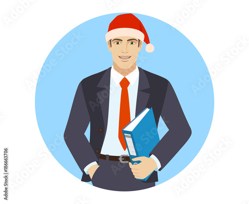Businessman in Santa hat with hand in pocket holding a folder