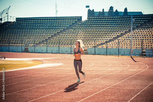 Athlete running on the tracks on a sunny day