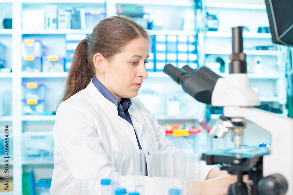 young woman lab assistant in a genetics lab young woman lab assistant in a genetics lab