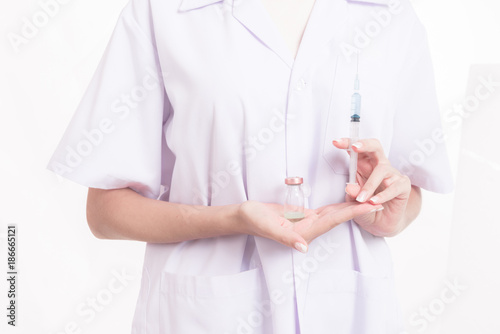 Professional medical career concept. Young female doctor white cloth isolated in white. Holding a syringe.
