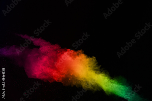 abstract colored dust explosion on a black background.abstract powder splatted background,Freeze motion of color powder exploding/throwing color powder, multicolored glitter texture. 
