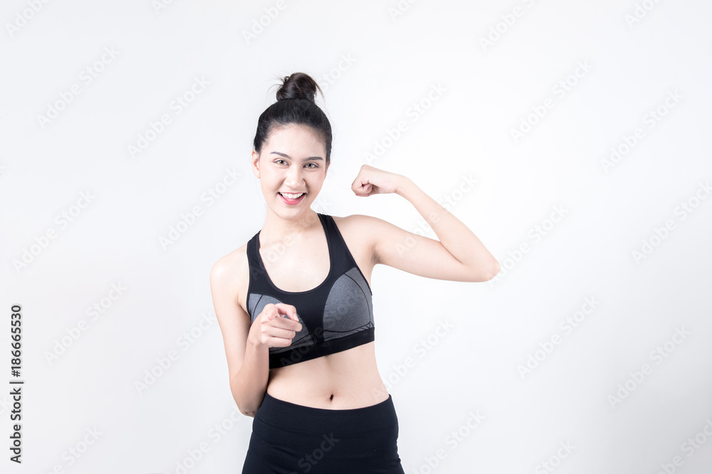 Fitness and health concept. Portrait of fit sport woman looking happy and confidence, isolated on white background. Chinese woman with black tank top and pants. Fitness and health concept. Portrait of fit sport woman looking happy and confidence, isolated on white background. Chinese woman with black tank top and pants.