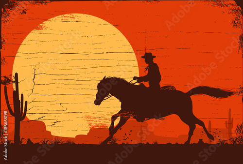 Silhouette of a cowboy riding a wild horse at sunset on a wooden sign, vector