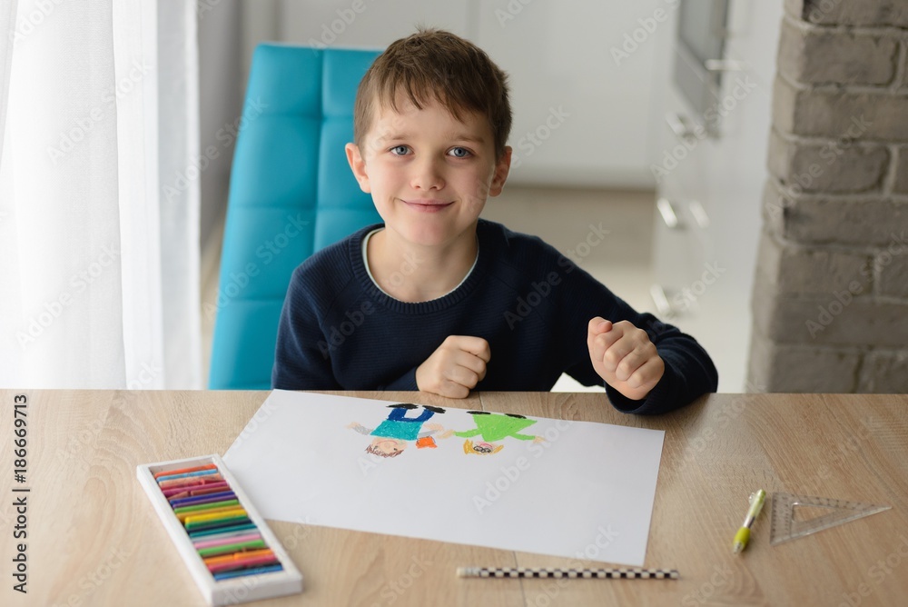 Happy 8 years boy child drawing a greeting card for his grandma