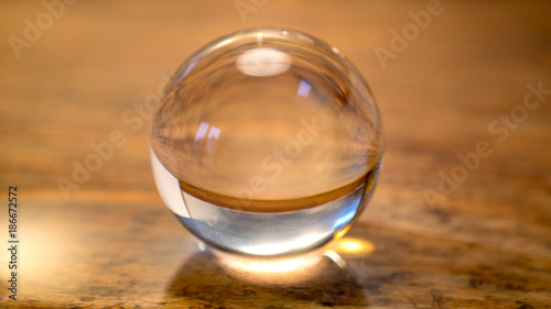 close up of glass sphere on wooden table