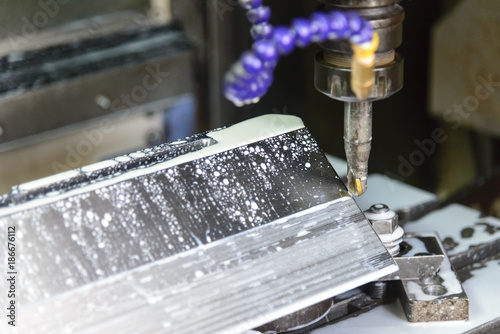 The CNC milling machine cutting the sample part.The end-mill tool cutting the mold part by CNC milling machine.