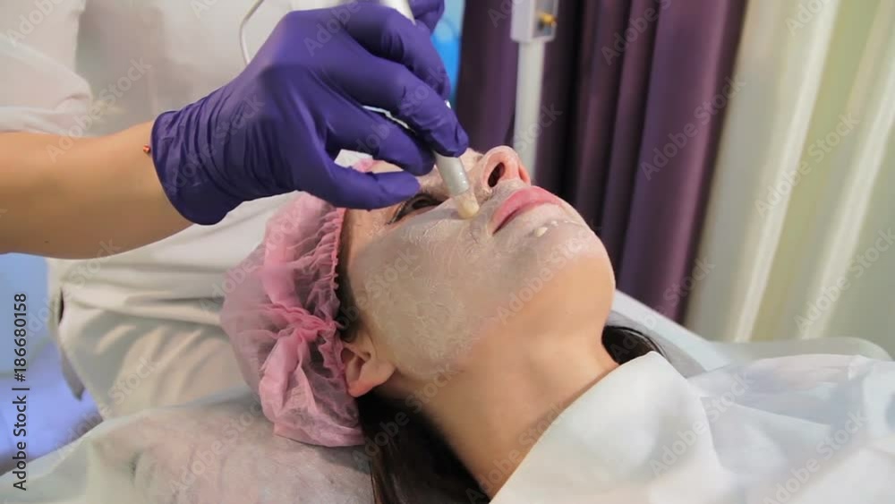 The woman on the procedure of lightening the skin. The patient's face in close-up. The appliance dermapen. Oriental medicine bbglow. The woman on the procedure of lightening the skin. The patient's face in close-up. The appliance dermapen. Oriental medicine bbglow.