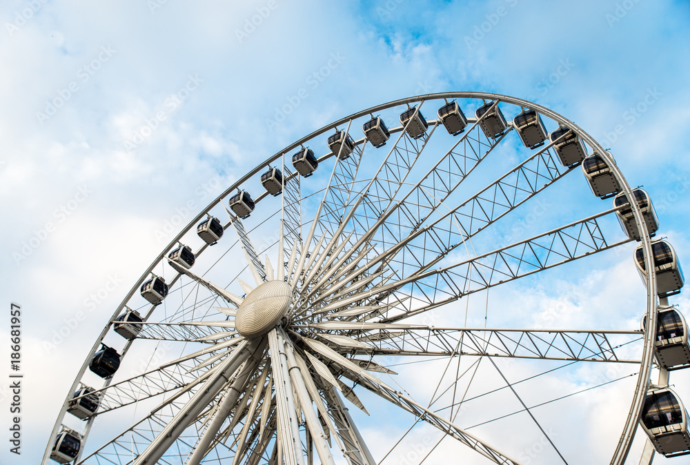 Gdansk, Poland - August 10, 2017: Big ferris wheel in the old town of Gdansk, blu sky background. Center or old town in Gdansk, European polish culture city near baltic sea. Summer travel in Poland.