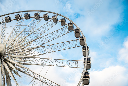 Gdansk, Poland - August 10, 2017: Big ferris wheel in the old town of Gdansk, blu sky background. Center or old town in Gdansk, European polish culture city near baltic sea. Summer travel in Poland.