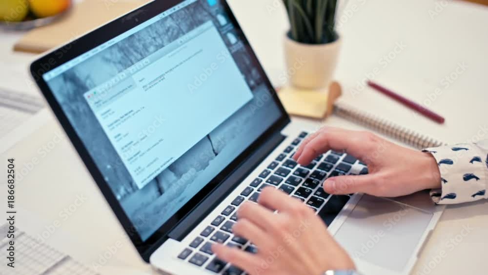 Business Lady in a Casual Shirt is Working on Laptop in a Cozy Office Room Typing Text Business Lady in a Casual Shirt is Working on Laptop in a Cozy Office Room Typing Text