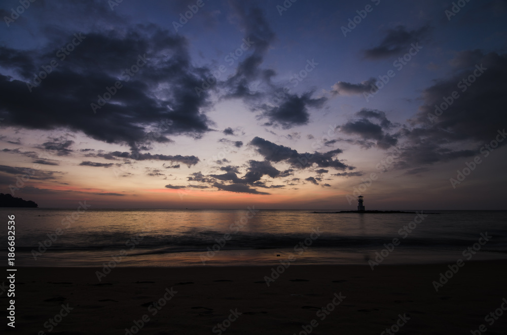 sunset on the beach and light house