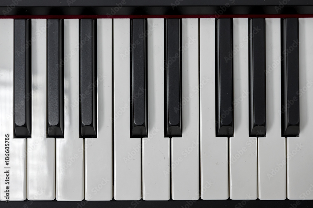 Simple and clean piano keys, one octave, music closeup, space for text on  black background Stock Photo | Adobe Stock