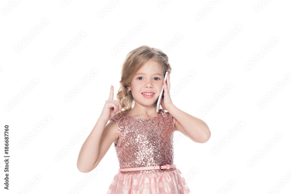 cheerful child pointing up while talking on smartphone, isolated on white cheerful child pointing up while talking on smartphone, isolated on white
