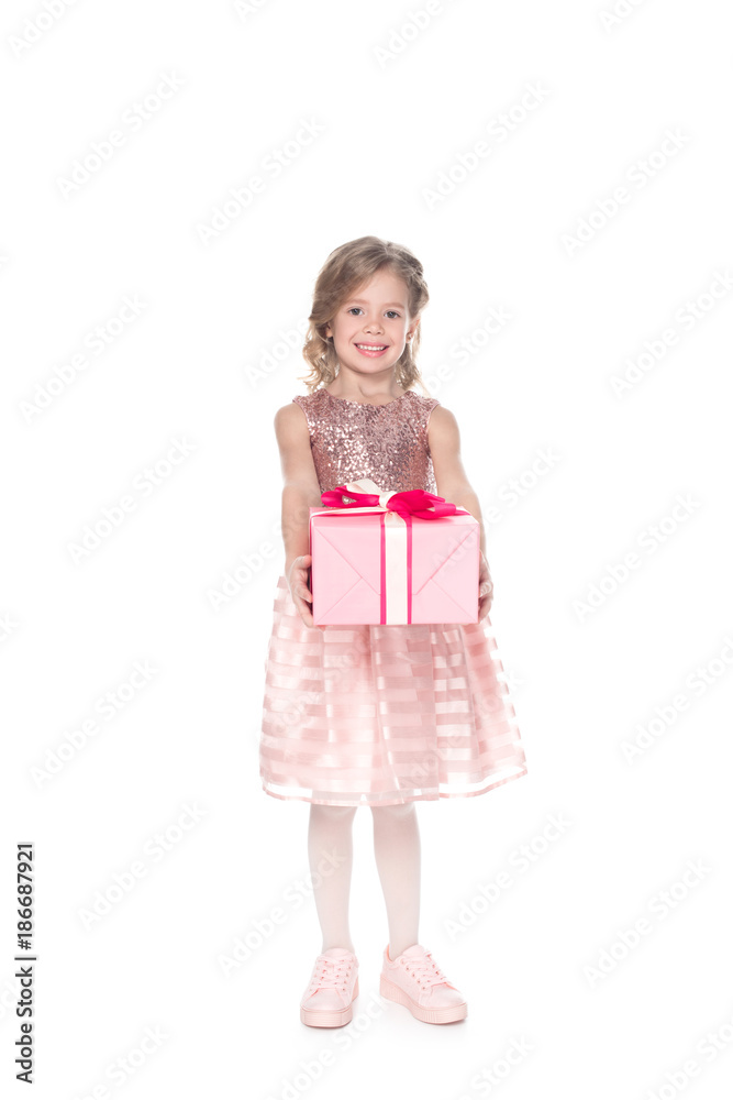 smiling kid in dress with sparkles holding present, isolated on white smiling kid in dress with sparkles holding present, isolated on white