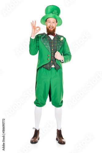 handsome leprechaun in green suit and hat with ok sign, isolated on white