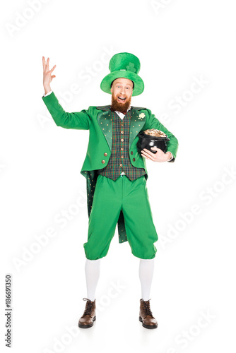 excited leprechaun gesturing and holding pot of gold, isolated on white