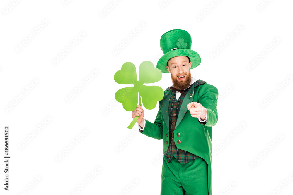 leprechaun in green suit pointing and holding clover, isolated on white leprechaun in green suit pointing and holding clover, isolated on white