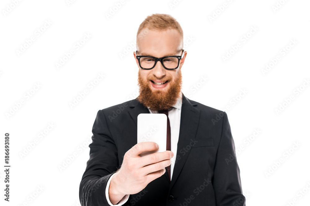 smiling young businessman in eyeglasses using smartphone isolated on white smiling young businessman in eyeglasses using smartphone isolated on white