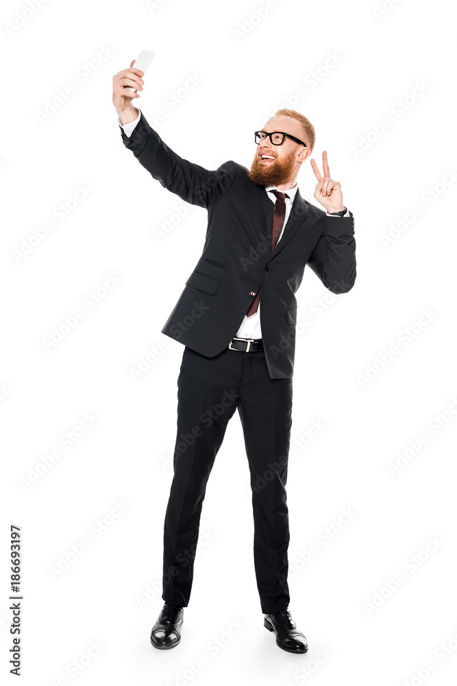 excited young businessman in eyeglasses taking selfie with smartphone isolated on white excited young businessman in eyeglasses taking selfie with smartphone isolated on white