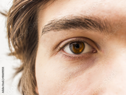Close up shot of a man's brown eye. Selective focus and shallow DOF