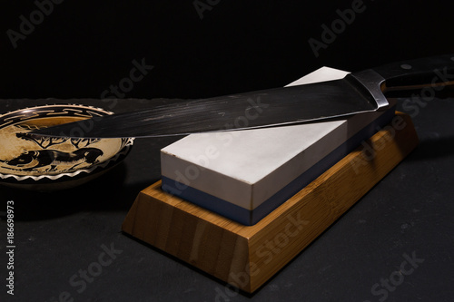 Photos sharpening knife with whetstone