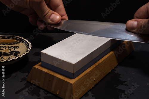 sharpening knife with whetstone photo