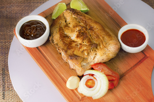 costelas de porco grelhadas suculentas acompanhada de molhos encima de uma mesa de madeira. Comida tipica de Minas Gerais prato tipo brasileiro photo