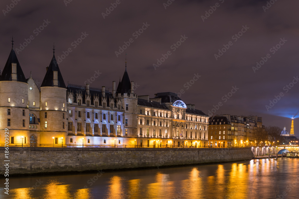 Night view of Conciergerie Castle and Pont Notre-Dame bridge
