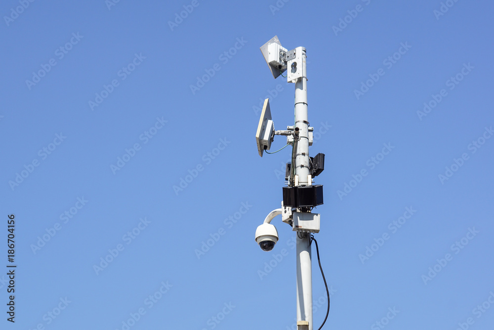 High tech overhead security camera with a blue sky High tech overhead security camera with a blue sky