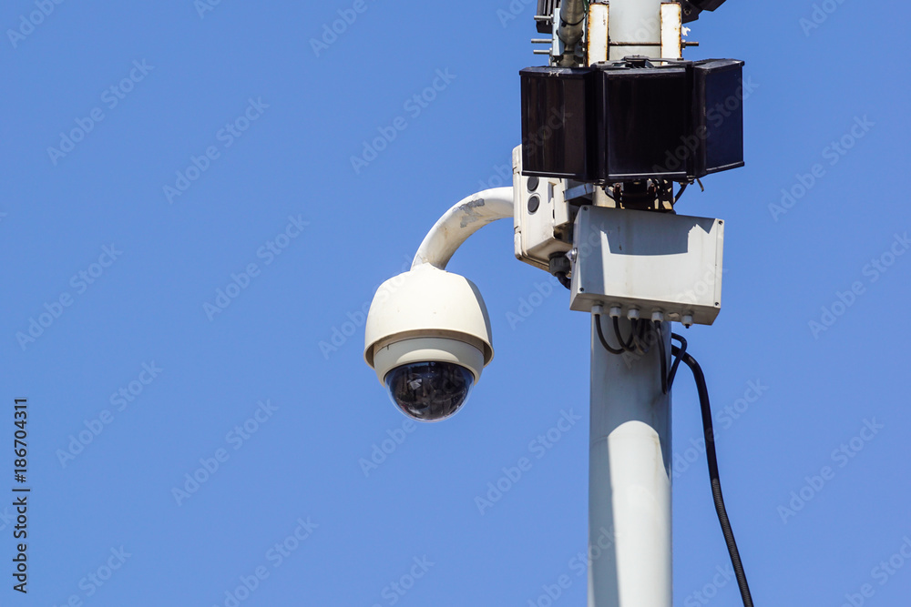 High tech overhead security camera with a blue sky High tech overhead security camera with a blue sky