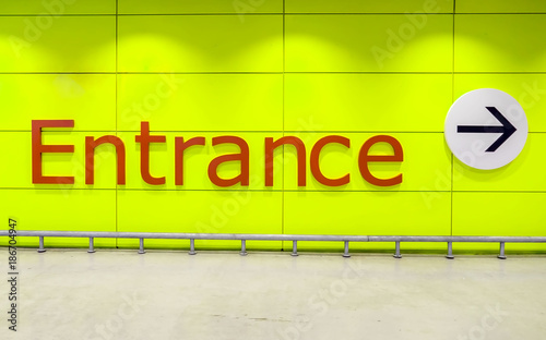 “Entrance” Text message on Yellow wall And the entry arrow.