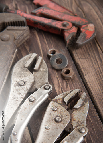 Pipe wrench,adjustable wrench on wooden background