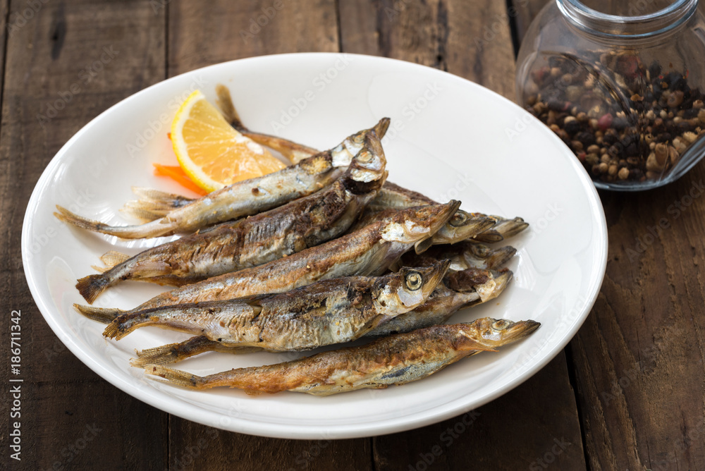 Grilled fish capelin or shishamo on white plate
Grilled fish capelin or shishamo on white plate