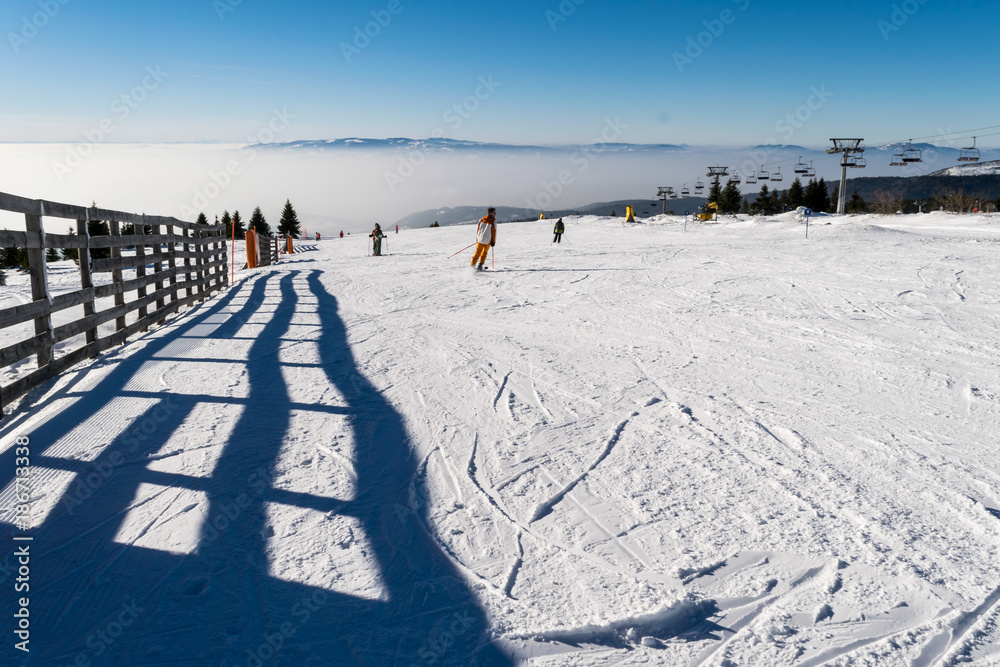 Ski slope, Snowy pathway with wooden fence in wintertime Kopaonik, Serbia