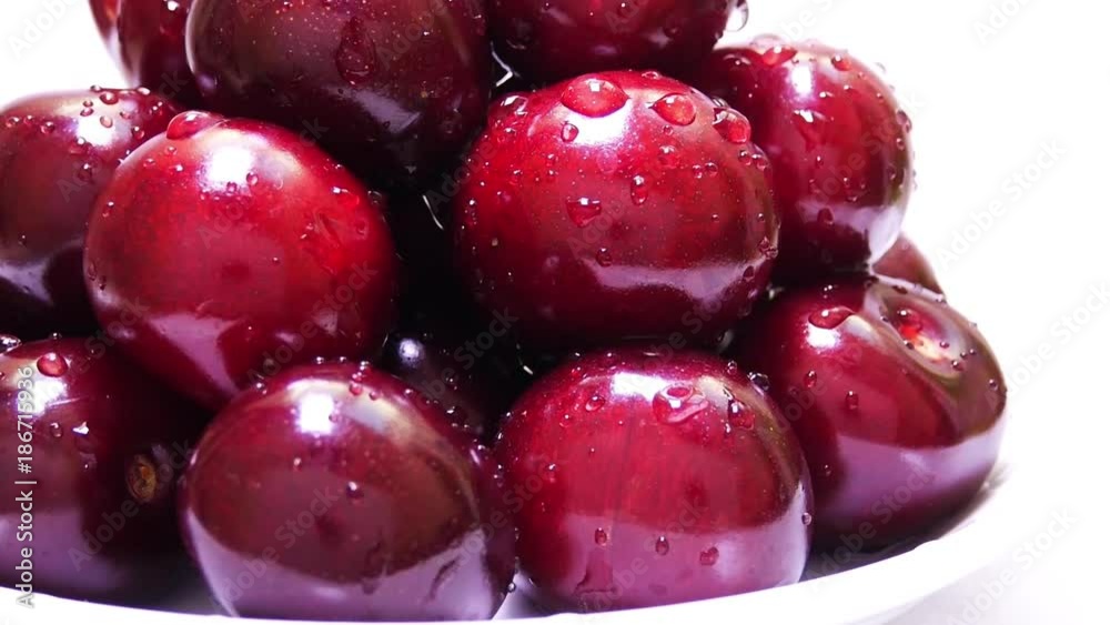 Red ripe cherry with water drops on a white background