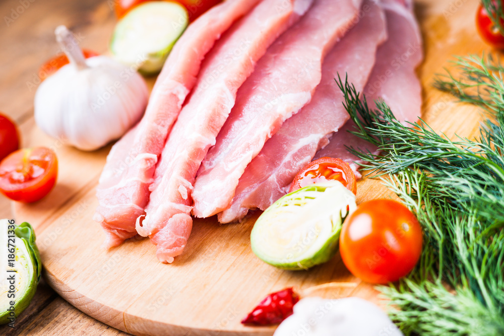 Slices of raw pork meat and vegetables Slices of raw pork meat and vegetables