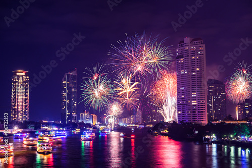 Firework downtown Happy New Year in Bangkok City Thailand. View form Taksin Bridge with chaopraya river.