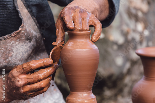 Man molding a clay pot