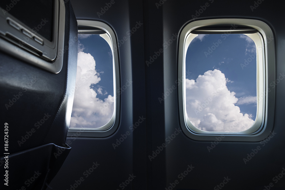 Clouds behind airplane window Clouds behind airplane window