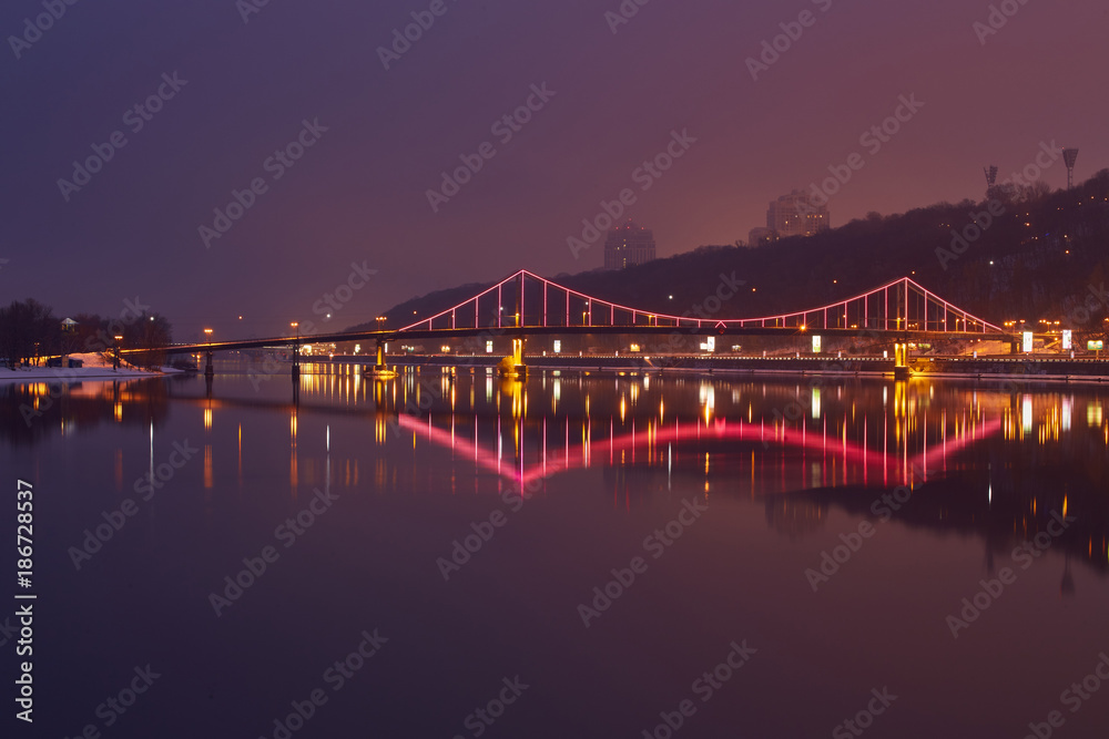 Night landscape. The city of Kiev, Ukraine, Europe. Pedestrian bridge across the Dnieper River.