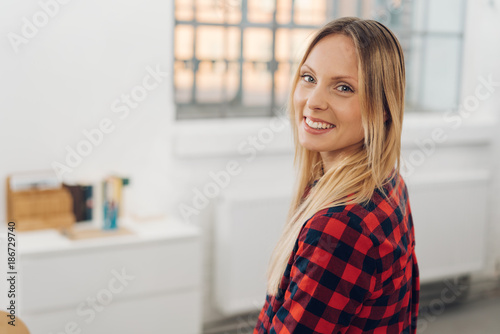 Happy young woman in a spacious white office Free Download Happy young woman in a spacious white office - GFXLoad